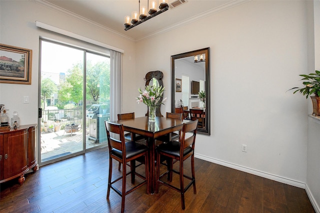 dining room with crown molding, an inviting chandelier, and dark wood-type flooring