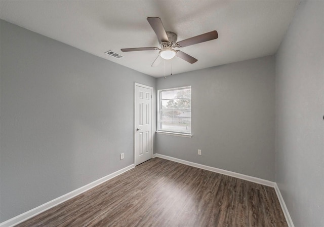 unfurnished room featuring dark hardwood / wood-style floors and ceiling fan