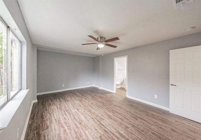 spare room with plenty of natural light, hardwood / wood-style floors, and ceiling fan