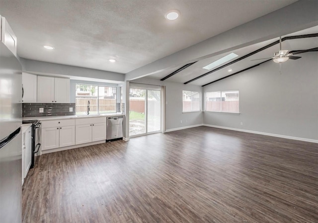 kitchen with black range with electric cooktop, dishwasher, sink, and white cabinets