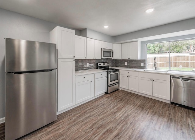 kitchen featuring appliances with stainless steel finishes, sink, and white cabinets