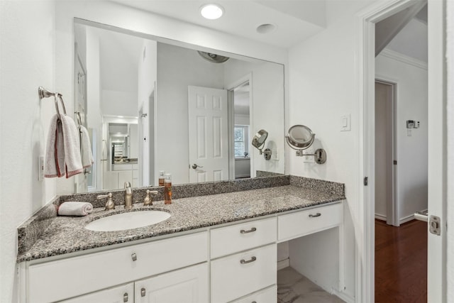 bathroom featuring vanity and ornamental molding