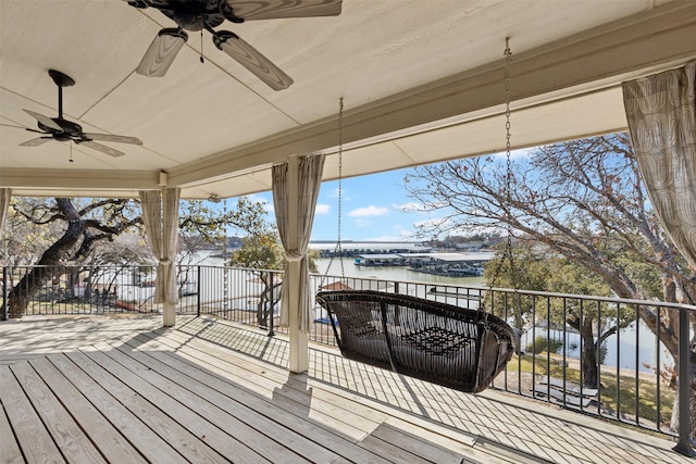 wooden terrace featuring a water view and ceiling fan