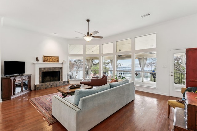 living room featuring dark hardwood / wood-style floors and ceiling fan