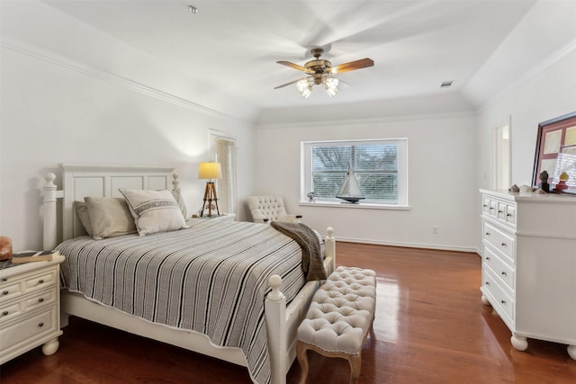 bedroom with dark hardwood / wood-style flooring, ornamental molding, and ceiling fan