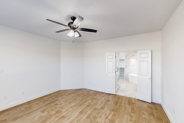 spare room with ceiling fan and light hardwood / wood-style floors