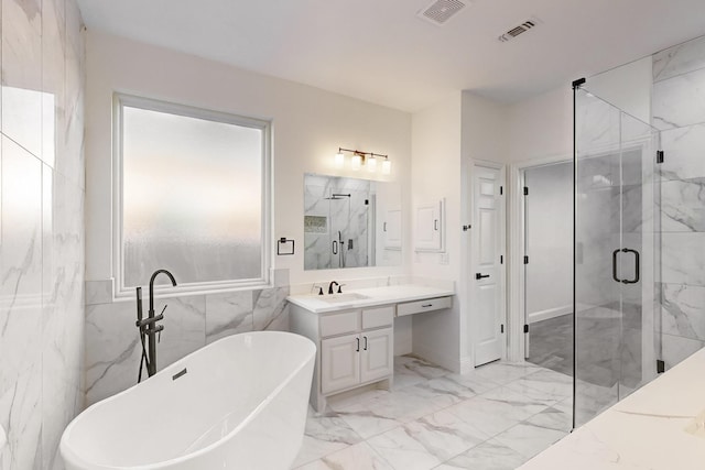 bathroom with vanity and independent shower and bath