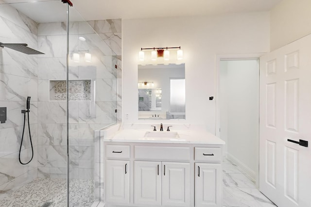 bathroom featuring a tile shower and vanity