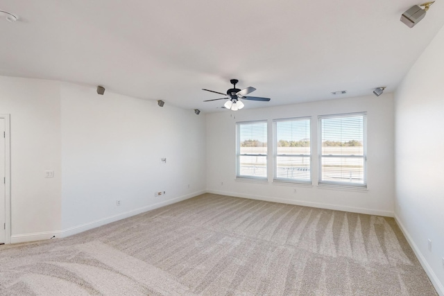 unfurnished room featuring ceiling fan and light carpet