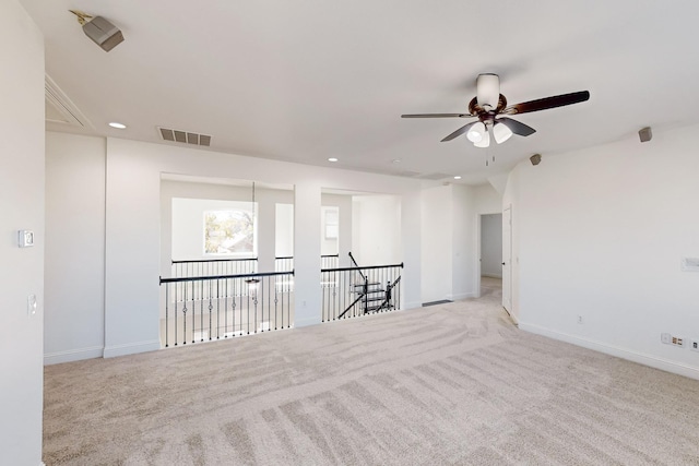 carpeted empty room featuring ceiling fan