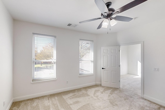 unfurnished room featuring ceiling fan and light colored carpet