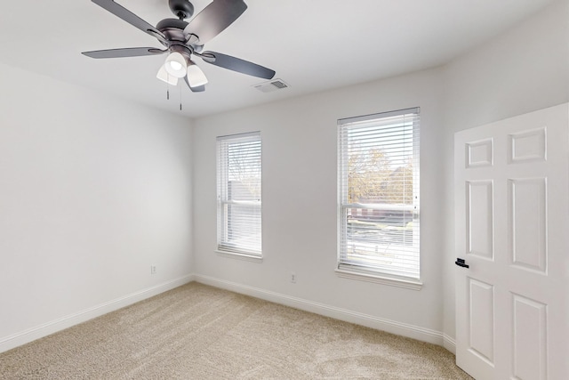 carpeted empty room featuring ceiling fan