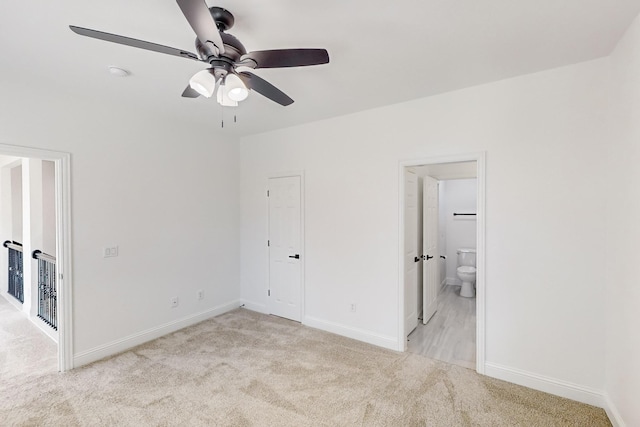 unfurnished bedroom with light carpet, connected bathroom, and ceiling fan