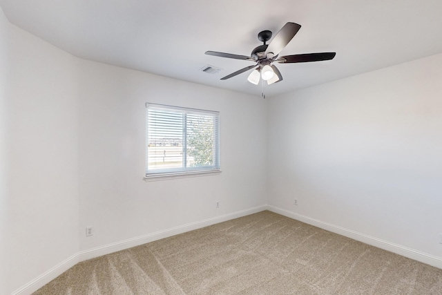 carpeted spare room with ceiling fan