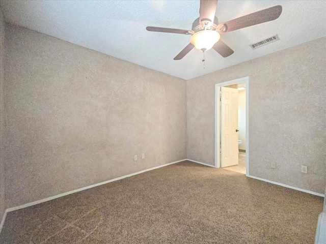 empty room featuring ceiling fan and carpet flooring