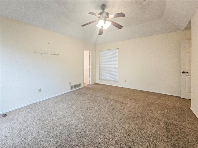 carpeted spare room featuring lofted ceiling and ceiling fan