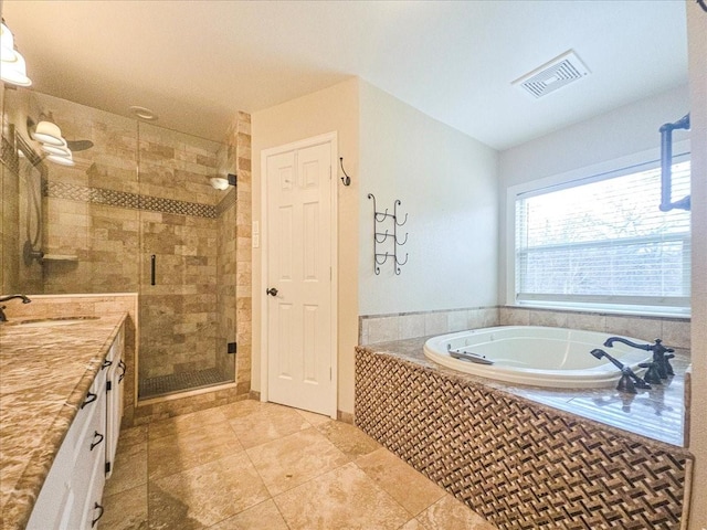 bathroom featuring vanity, shower with separate bathtub, and tile patterned floors