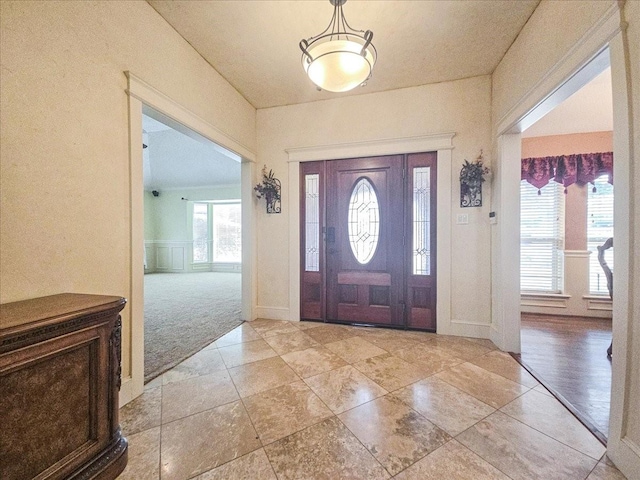 entrance foyer with light colored carpet