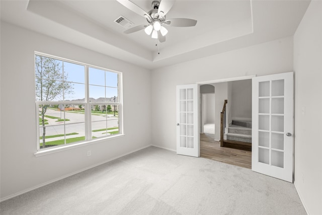 3046 Arbor Grv, Midlothian, TX 76065 - unfurnished bedroom with a raised ceiling, carpet flooring, french doors, and a ceiling fan