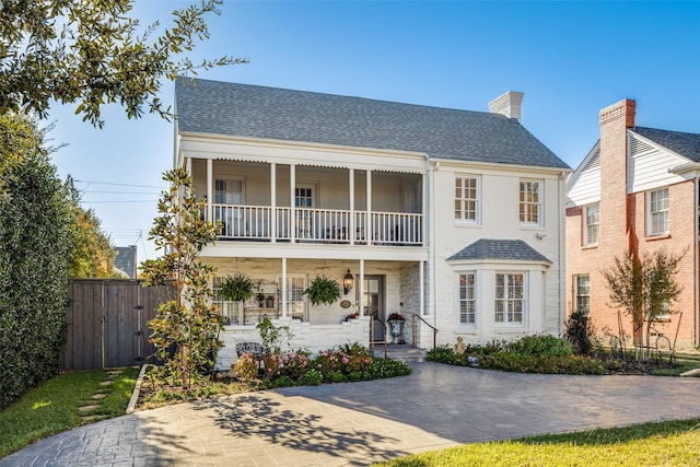 view of front of house with a balcony and covered porch