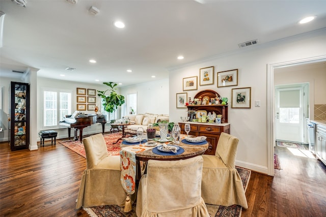 dining room with crown molding and dark hardwood / wood-style flooring