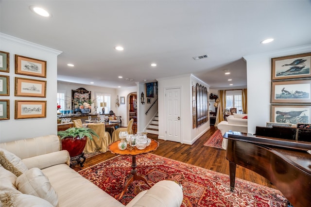 living room featuring ornamental molding and dark hardwood / wood-style floors