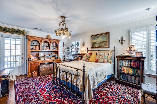 bedroom with dark wood-type flooring, crown molding, and multiple windows