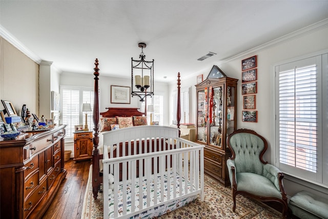 bedroom with crown molding, dark hardwood / wood-style flooring, and an inviting chandelier