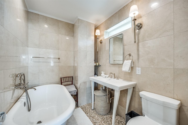 bathroom featuring tile walls, crown molding, a tub, and toilet