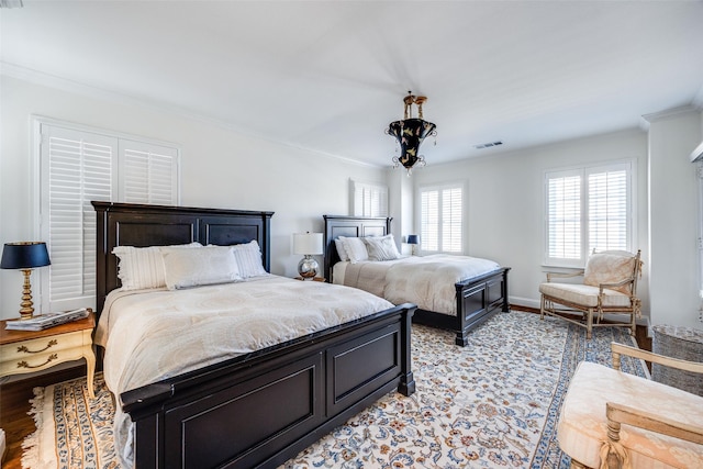 bedroom with crown molding and light hardwood / wood-style flooring