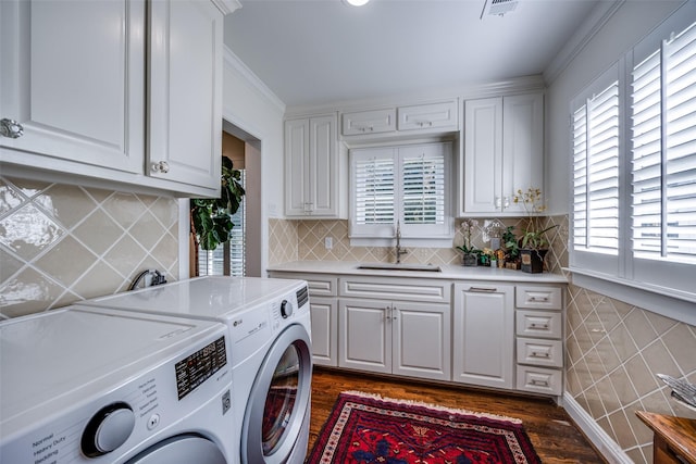 laundry area with cabinets, independent washer and dryer, plenty of natural light, and sink