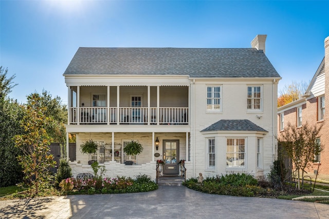 view of front of home featuring a balcony and covered porch