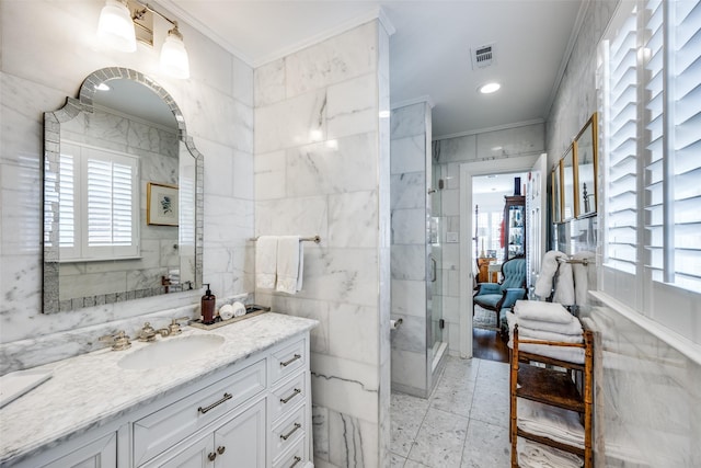 bathroom with crown molding, a shower with shower door, and tile walls