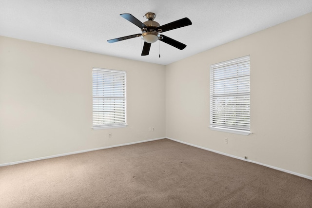 spare room with a textured ceiling, ceiling fan, and carpet flooring