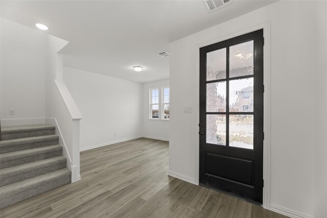 workout area featuring a raised ceiling, ornamental molding, and a towering ceiling