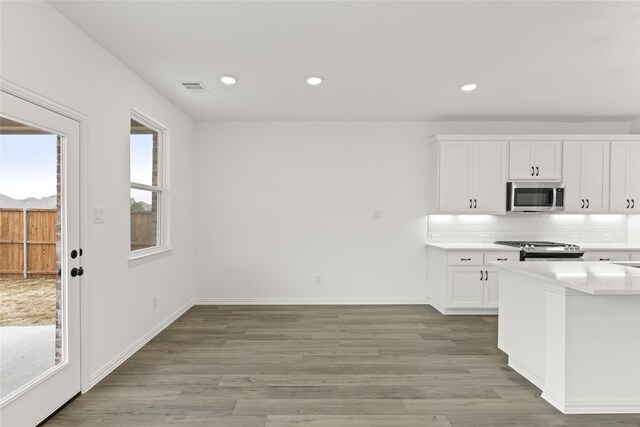 exercise room featuring ornamental molding, a raised ceiling, and french doors