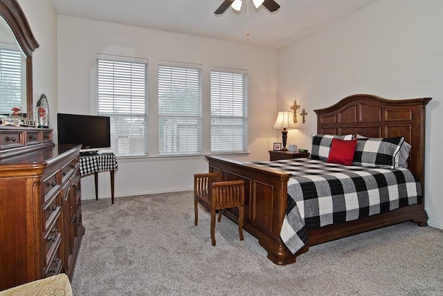 carpeted bedroom with multiple windows and ceiling fan