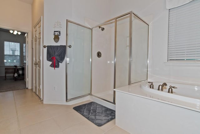 bathroom featuring tile patterned floors and independent shower and bath