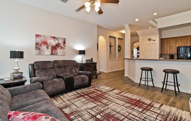 living room with hardwood / wood-style flooring and ceiling fan