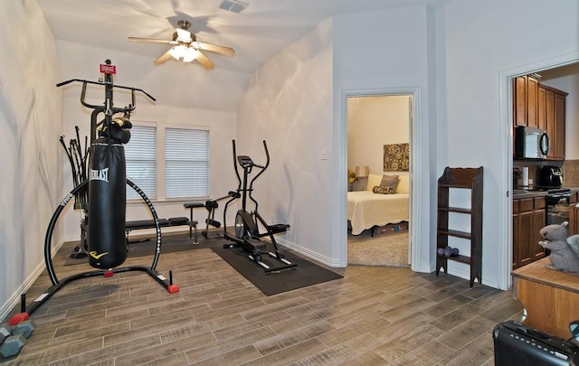 exercise room featuring dark hardwood / wood-style flooring and ceiling fan