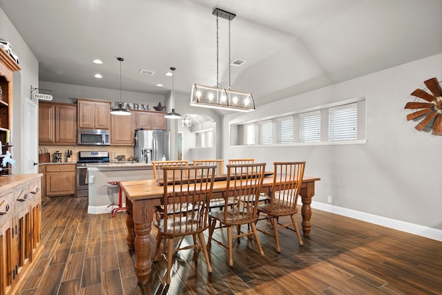 dining area with dark hardwood / wood-style flooring and lofted ceiling