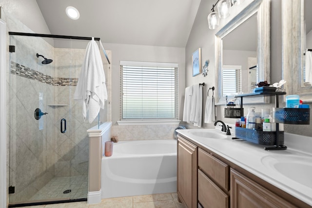 bathroom featuring vanity, vaulted ceiling, tile patterned floors, and plus walk in shower