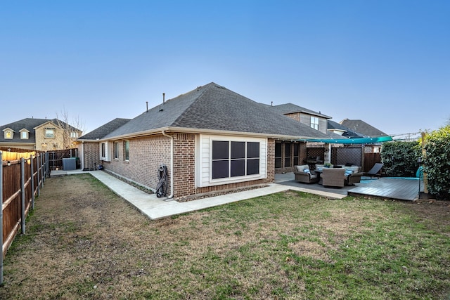 rear view of property with central AC, a lawn, outdoor lounge area, a deck, and a patio