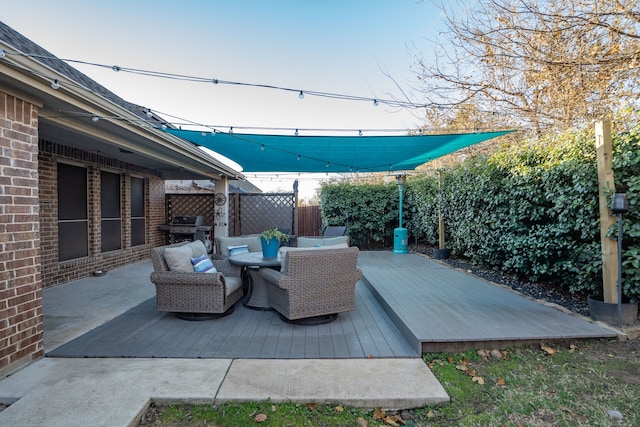 wooden terrace with area for grilling and an outdoor hangout area