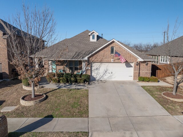 view of front of property featuring a garage and a front yard