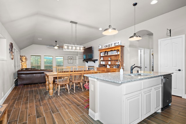 kitchen with an island with sink, sink, white cabinets, hanging light fixtures, and stainless steel dishwasher