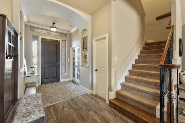 foyer entrance featuring crown molding and hardwood / wood-style floors