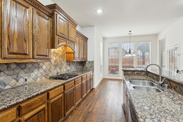 900 Thimbleberry Dr, Mckinney, TX 75071 - kitchen with dark wood-style floors, a sink, gas stovetop, tasteful backsplash, and stone counters