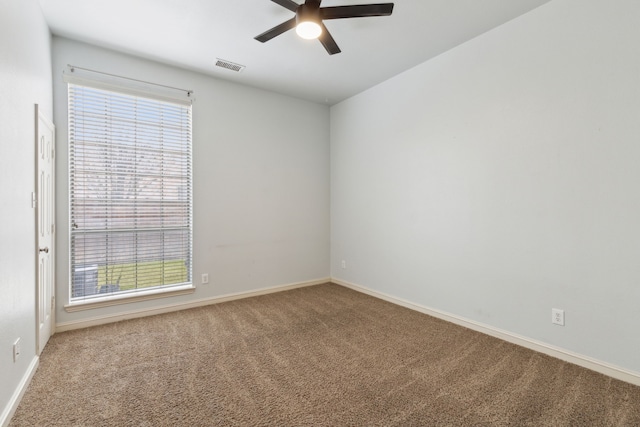 carpeted spare room with ceiling fan