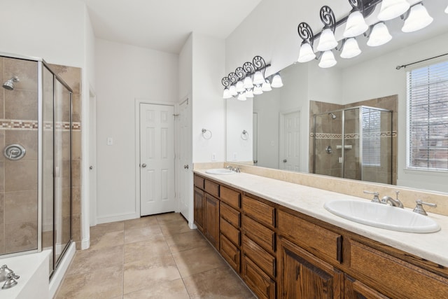 bathroom featuring vanity, a shower with shower door, and tile patterned flooring